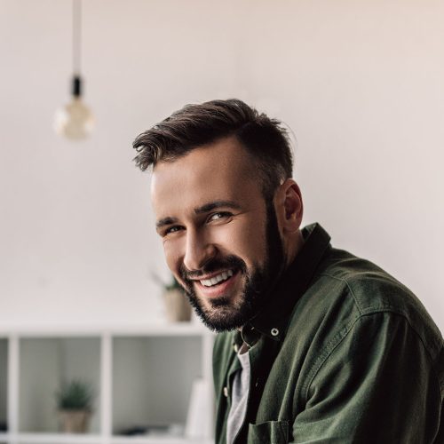 bearded-businessman-in-casual-clothing-smiling-at-NVFMJUV.jpg